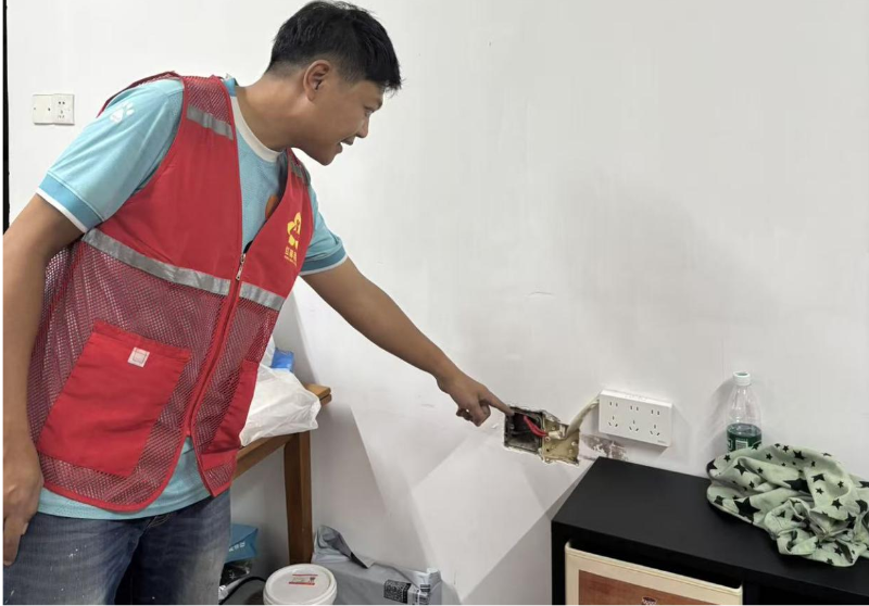 Volunteers checking electrical sockets