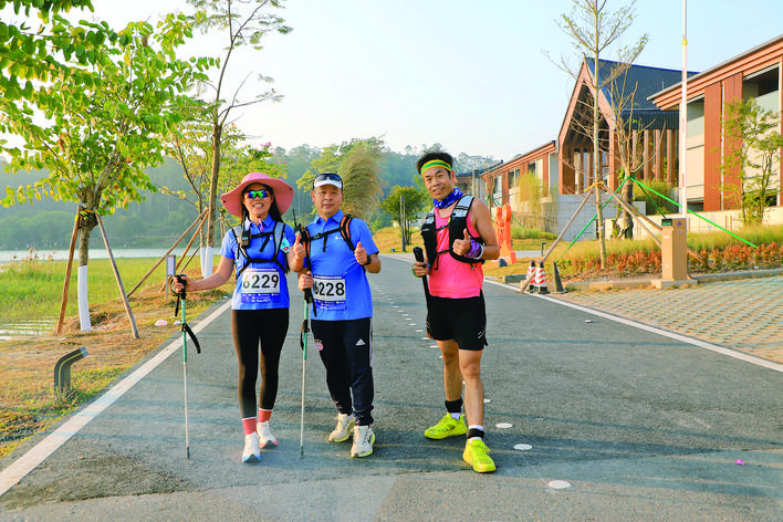Hikers take photos to check in front of the beautiful scenery.